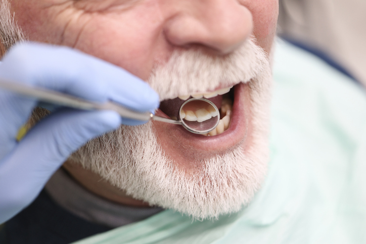 Senior caucasian male at a periodontist's office getting exam.